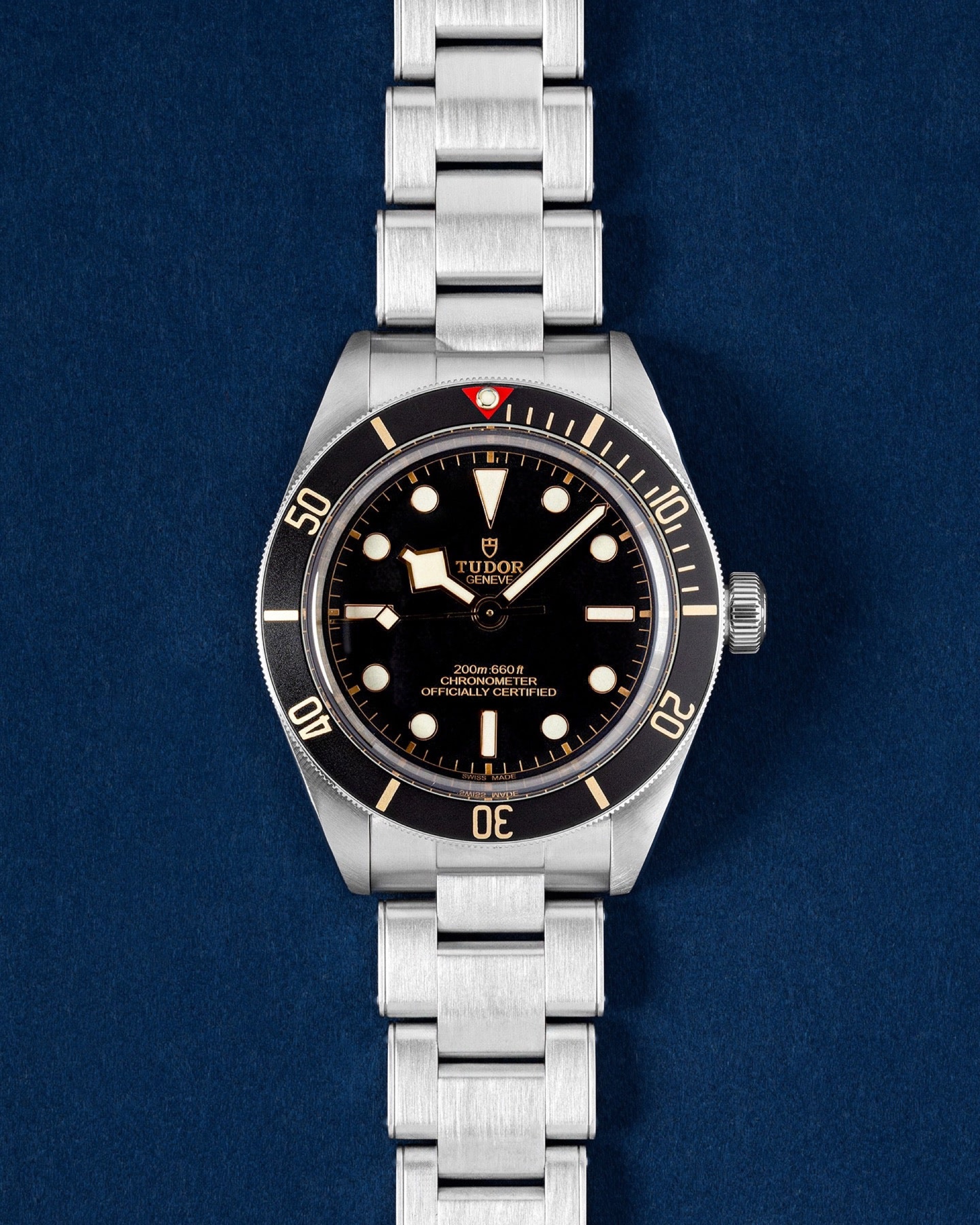 Tudor Black Bay Fifty-Eight M79030N on its steel bracelet, laid on navy velvet